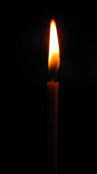 mysterious church candle on a dark background.