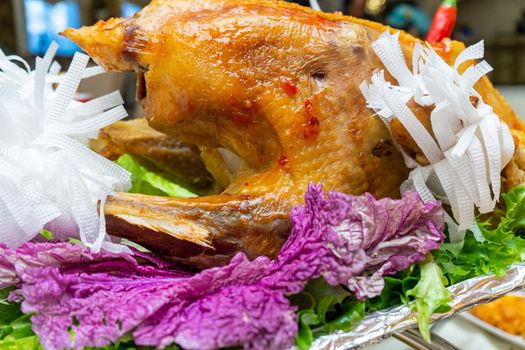 A large roast turkey on the holiday table at Thanksgiving.