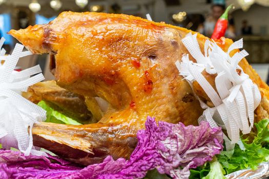 A large roast turkey on the holiday table at Thanksgiving.