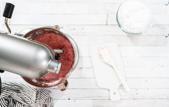 Flat lay. Preparing raspberry cream cheese buttercream in kitchen mixer for bake chocolate raspberry cupcakes.