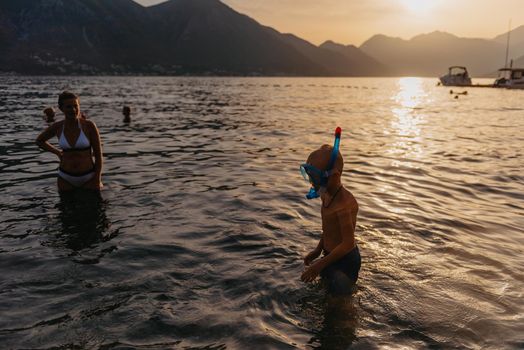 Cute happy little boy swimming and snorking in the sea. Child wearing snorkeling mask diving underwater, little boy enjoy swim underwater on tropical resort