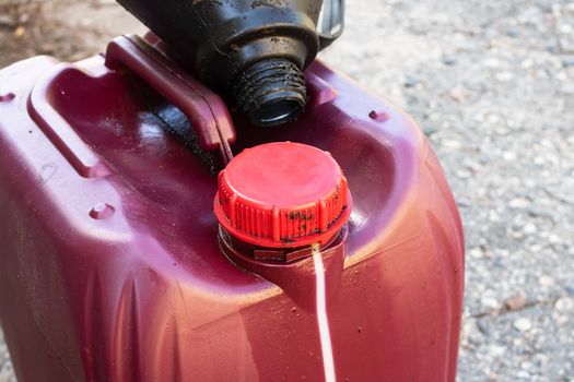 Large red canister of engine oil close up