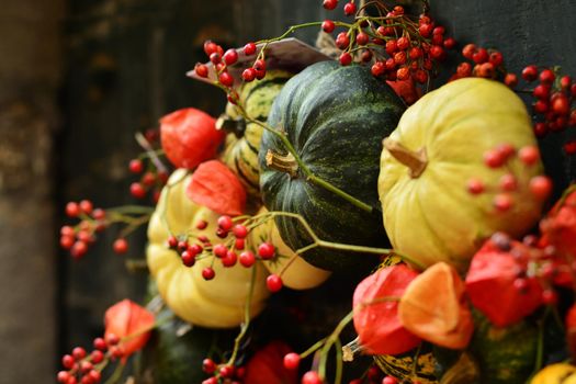 Composition of the small pumpkins and zucchinis on a vintage door Halloween pumpkins