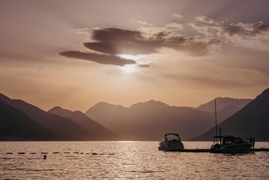 Silhouette of sailing yachts in the sea on beautiful sunset backgroung.