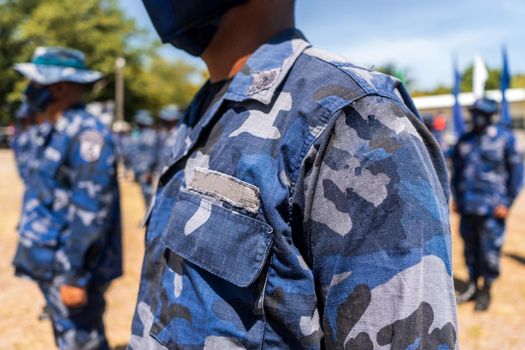 Unrecognizable Latino sailors in blue military uniform standing in line