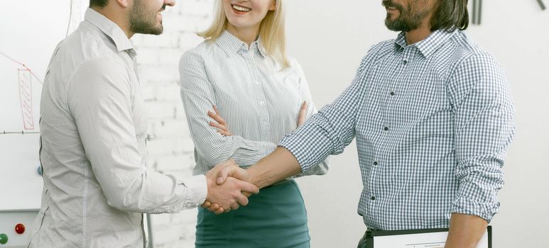 Business partners shaking hands in agreement. Greeting colleagues shaking hands, businessmen greeting each other shaking hands. Cropped shot. Toned image.