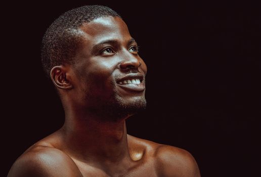 Black african man smile studio in beautiful style on black background. Black background. Isolated studio portrait. Beautiful model.