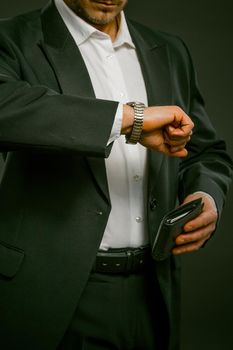 Time is money. Hand with watch, businessman in suit for clothing design. Classic illustration. Business technology.