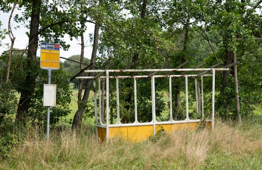 old abandoned bus stop in holland overgrown with plans and grass