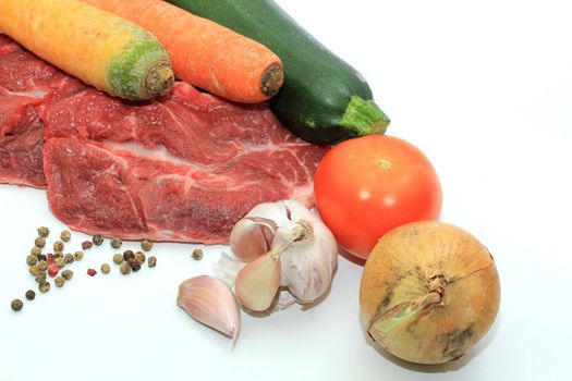 Raw beef, a zucchini or courgette, some garlic, carrot and a tomato