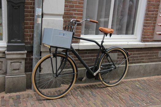 Retro style transportation bike near a brick wall. Plastic beverage crate to carry around the groceries