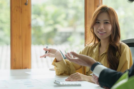 Administration or Accountant discussing with partner are meeting to audit finance planning sales to meet targets set in next year. Finance concept.