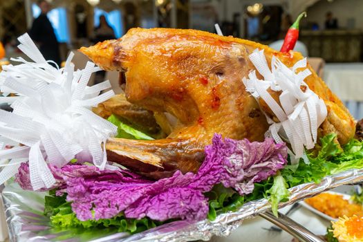 A large roast turkey on the holiday table at Thanksgiving.