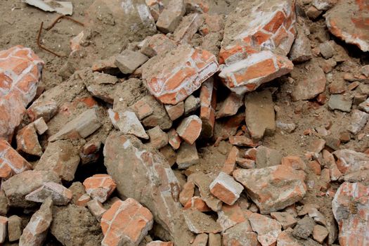 Pile of broken red bricks on construction site