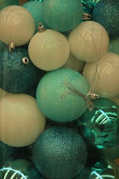 Christmas ornaments in teal and pastel blue colors in a christmas retail shop