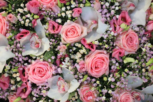 Pink and white  roses and orchids in a floral wedding decoration