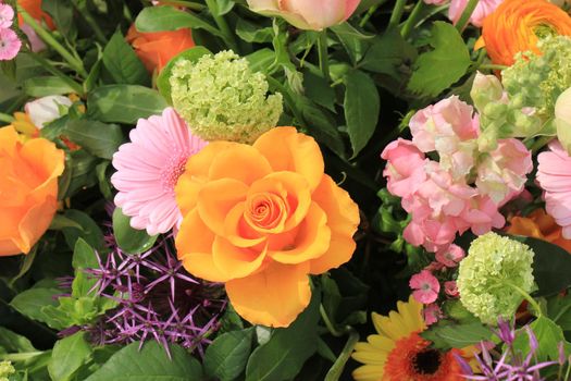 Mixed flower arrangement: various flowers in different shades of pink and orange for a wedding