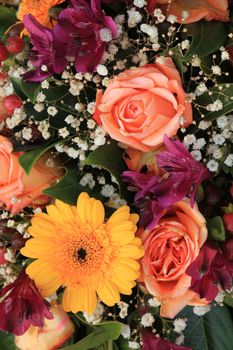 Mixed flower arrangement: various flowers in different shades of pink and orange for a wedding