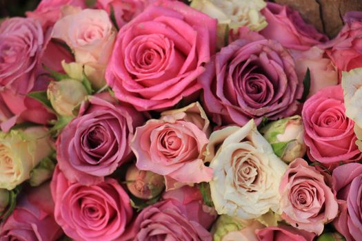 Mixed pink roses in a floral wedding decoration