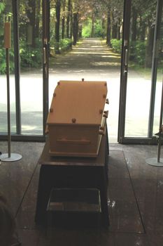 Plain light wooden coffin in a crematorium