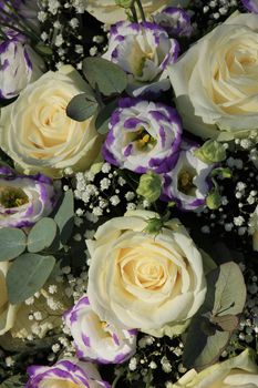 White roses and purple Lisianthus in a mixed bridal bouquet