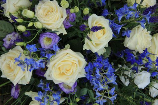 Mixed wedding flower arrangement: various flowers in different shades of blue and purple