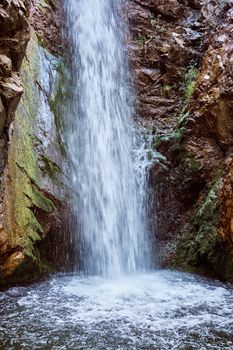 Picturesque Millomeris waterfall and stream in the forest at Troodos mountains Cyprus, amazing natural landmark. Tourism, vacation, traveling, leisure concept.