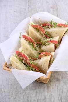 Wheat toast sandwich  with cream cheese with microgreen onion sprouts and salami. Healthy and fresh food.