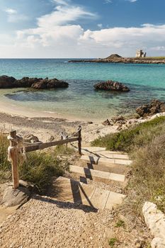 Turquoise sea and blue sky. Breathtaking natural landscapes. Fantastic beach of fine white sand, staircase leading to water, Puglia, Italy. Tourism, travel concept.