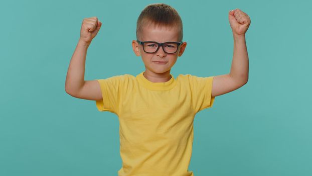 I am strong and independent. Little toddler children boy showing biceps and looking confident, feeling power strength to fight for rights, energy to gain success win. Preschool kid on blue background