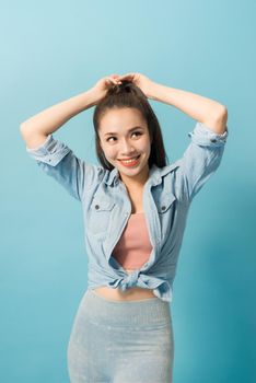 Active young woman in casual summer outfit having fun indoor.