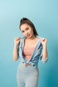 Active young woman in casual summer outfit having fun indoor.