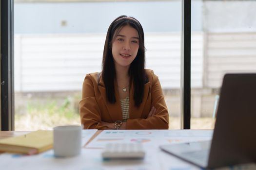 Accountant concept. Business woman sitting at office and look at camera.