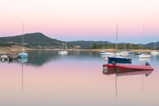 Montbel, France. 2022 August 2 . Sunset on Lake Montbel in Ariege with the boats in the summer of 2022.