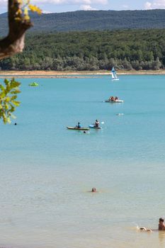 Montbel, France. 2022 August 2 . People practicing water sports on Lake Montbel in Ariege with the boats in the summer of 2022.