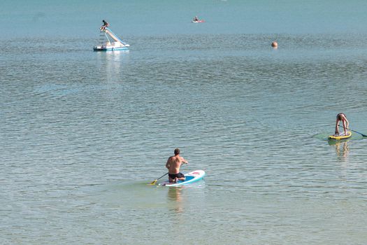 Montbel, France. 2022 August 2 . People practicing water sports on Lake Montbel in Ariege with the boats in the summer of 2022.