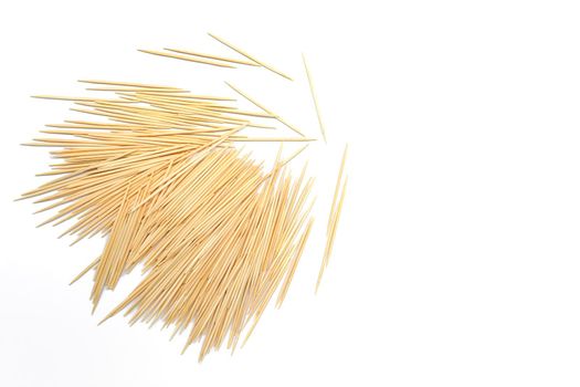 Pile of wooden toothpicks on white background. Copy space. Directly above. Flat lay.