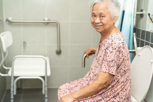 Asian senior or elderly old lady woman patient use toilet bathroom handle security in nursing hospital ward, healthy strong medical concept.