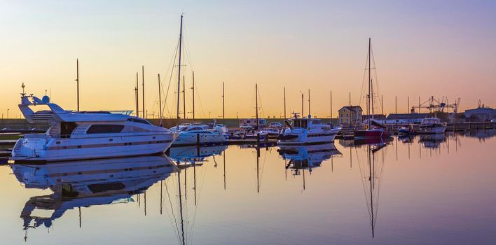 Bremerhaven Germany 12. March 2011 Sunset and cityscape and coast panorama of ATLANTIC Hotel Sail City lighthouse architecture ships yachts boats dike and landscape of Bremerhaven in Germany.