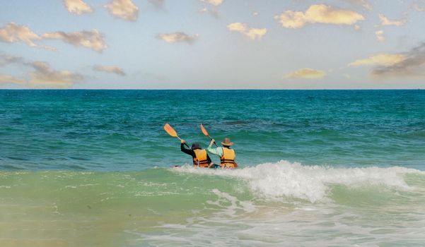 Two fellow kayakers went out in the evening to swim in a kayak in the sea