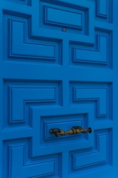 New closed modern bright blue door close up