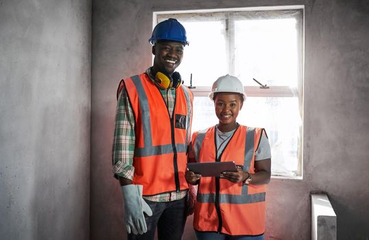 The king and queen of concrete. a young man and woman using a digital tablet while working at a construction site