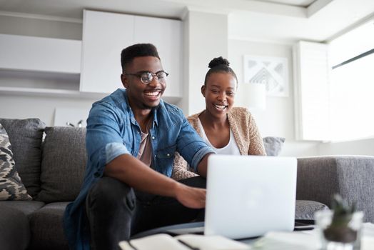 Budgeting has become such a breeze for them. a young couple using a laptop together at home