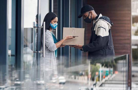 Fighting coronavirus one contactless payment at a time. a masked young man and woman using smartphones during a home delivery