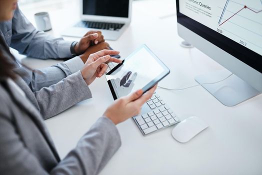 Accounting kept simple with smart software. a businessman using a digital tablet to analyse financial data in a modern office