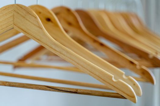 Close-up of wardrobe with wooden clothes hanger