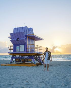 Miami beach, young men on the beach in America, lifeguard hut Miami beach Florida. caucasian men on the beach during sunset