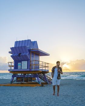 Miami beach, young men on the beach in America, lifeguard hut Miami beach Florida. caucasian men on the beach during sunset