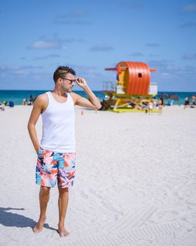 Miami beach, young men on the beach in America, lifeguard hut Miami beach Florida. caucasian men on the beach during sunset