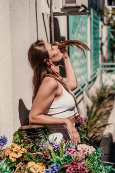 a beautiful girl in a white training suit is going to ride a bike on a sunny summer day